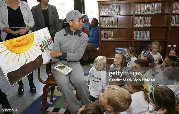 Lil' Mama reads to children at Jump Start's "Read for the Record" at Brooklyn Public Library's Central Library on October 8, 2009 in the Brooklyn...