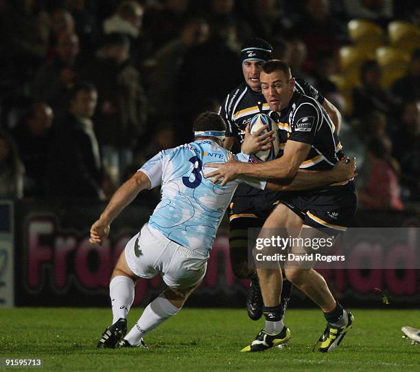 Chris Latham of Worcester is tackled by Bruce Douglas during the Amlin Challenge Cup match between Worcester Warriors and Montpellier at Sixways on...