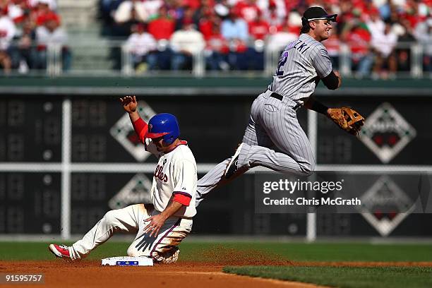 Shane Victorino of the Philadelphia Phillies is forced out at second base by Troy Tulowitzki of the Colorado Rockies on a fielder's choice hit by...