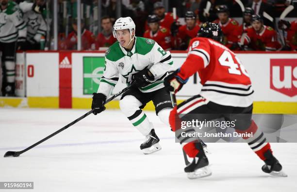 Julius Honka of the Dallas Stars advances the puck against Vinnie Hinostroza of the Chicago Blackhawks at the United Center on February 8 2018 in...