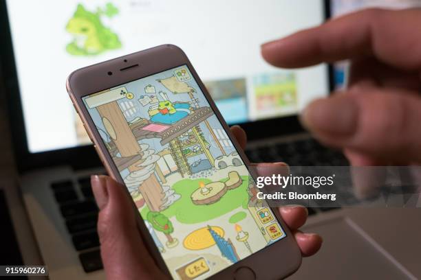 Hit-Point Co. Game app Tabi Kaeru, or Travel Frog, is arranged for a photograph on a smartphone in Tokyo, Japan, on Monday, Jan. 30, 2018. The game...