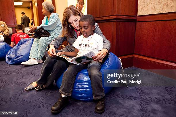 Rep. Loretta Sanchez reads to a child at Jump Start's "Read for the Record" at Capitol Hill on October 8, 2009 in Washington, DC.