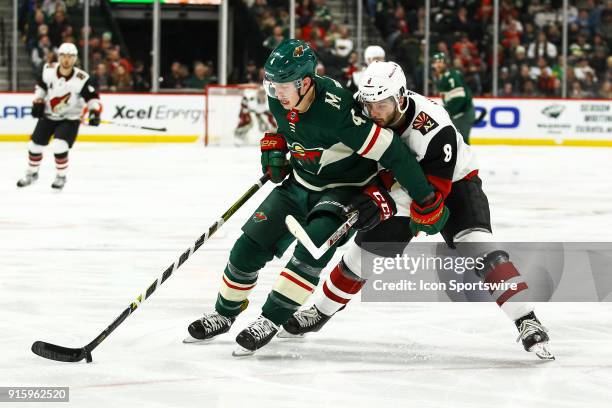 Minnesota Wild defenseman Mike Reilly protects the puck from Arizona Coyotes center Tobias Rieder during the Western Conference game between the...