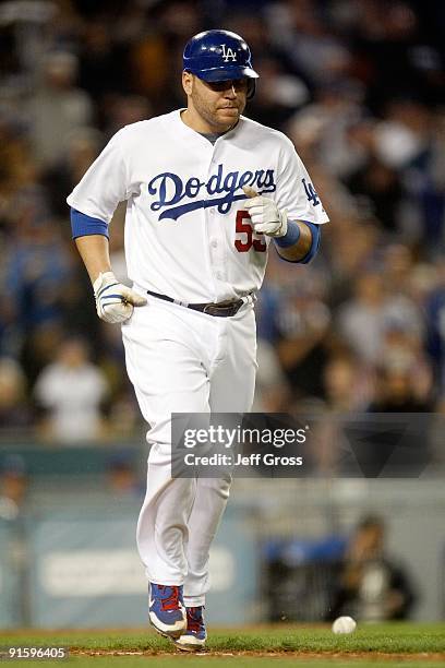 Russell Martin of the Los Angeles Dodgers heds to first base after getting hit in the back against the St. Louis Cardinals in Game One of the NLDS...