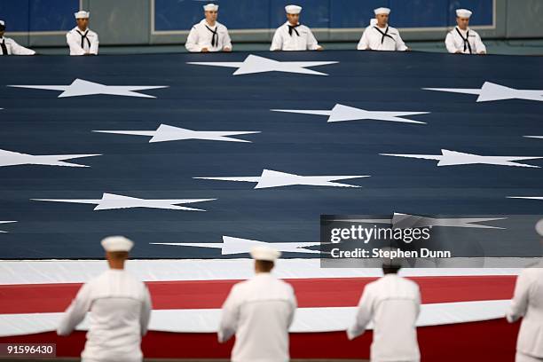 Sailors roll out the U.S. Flag before the Los Angeles Dodgers take on the St. Louis Cardinals in Game One of the NLDS during the 2009 MLB Playoffs at...