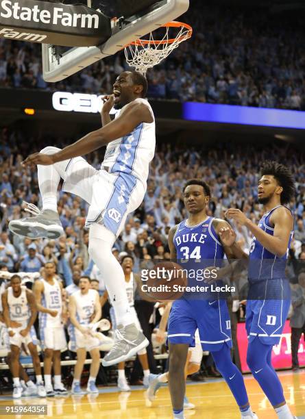 Teammates Wendell Carter Jr and Marvin Bagley III of the Duke Blue Devils watch as Theo Pinson of the North Carolina Tar Heels reacts after a dunk...