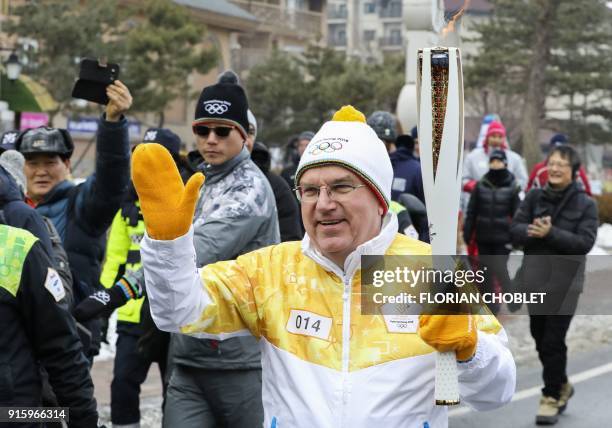 President of the International Olympic Committee Thomas Bach takes part the Pyeongchang 2018 Torch Relay ahead of the start of the Pyeongchang 2018...