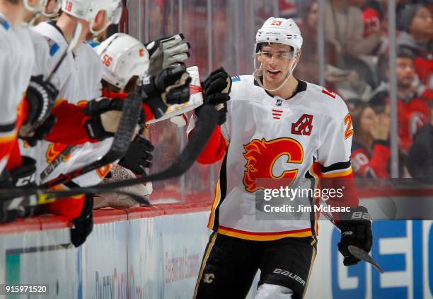 Sean Monahan of the Calgary Flames celebrates his second goal of the second period against the New Jersey Devils with his teammates on February 8,...