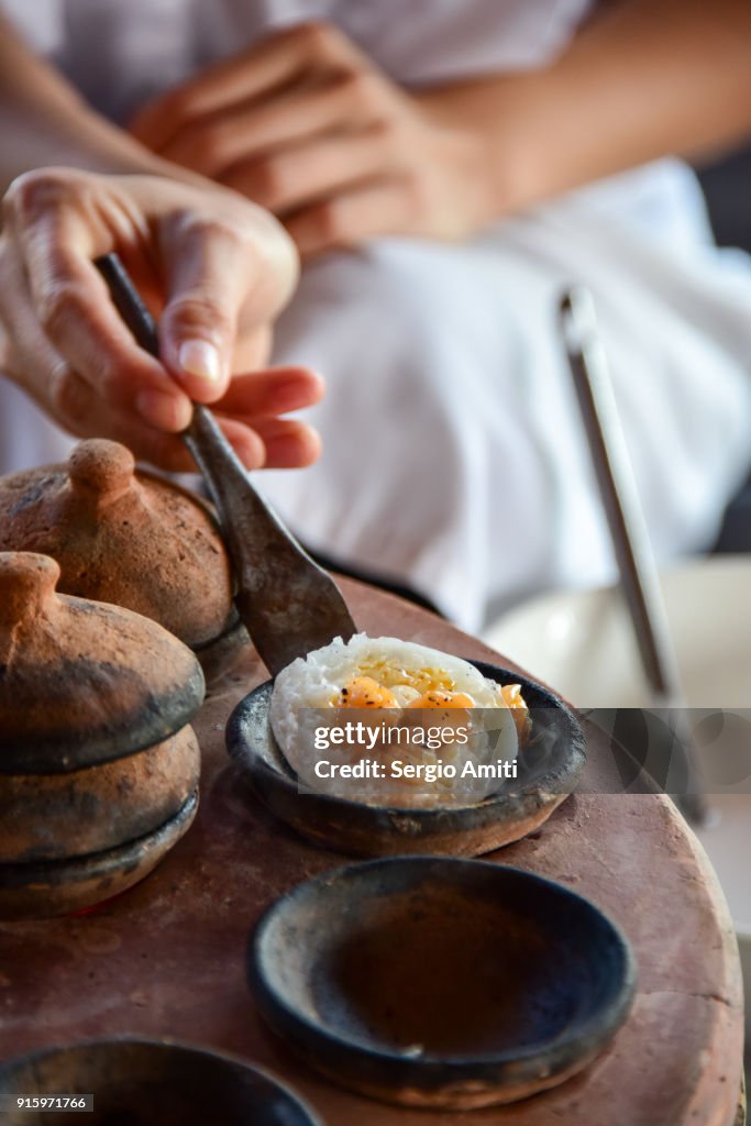 Removing a Bánh Bèo, Vietnamese savory rice tea cake from its baking mould using a spatula