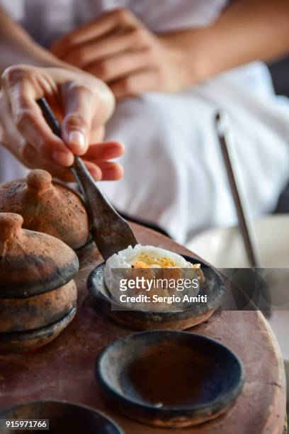 removing a bánh bèo, vietnamese savory rice tea cake from its baking mould using a spatula - nha trang stock pictures, royalty-free photos & images