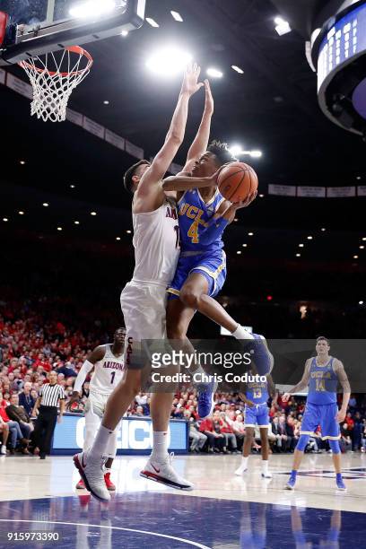 Jaylen Hands of the UCLA Bruins drives against Dusan Ristic of the Arizona Wildcats during the first half of the college basketball game at McKale...