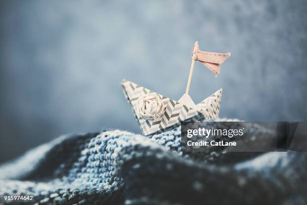 handmade origami boat on handmade waves - origami boat stock pictures, royalty-free photos & images