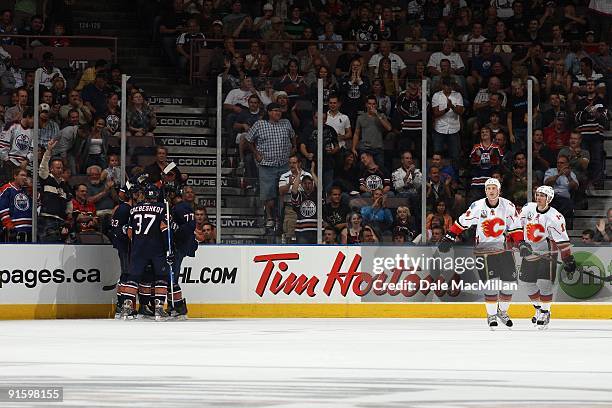 Ales Hemsky, Denis Grebeshkov and Tom Gilbert of the Edmonton Oilers celebrate a goal as Jay Bouwmeester and Fredrik Sjostrom of the Calgary Flames...