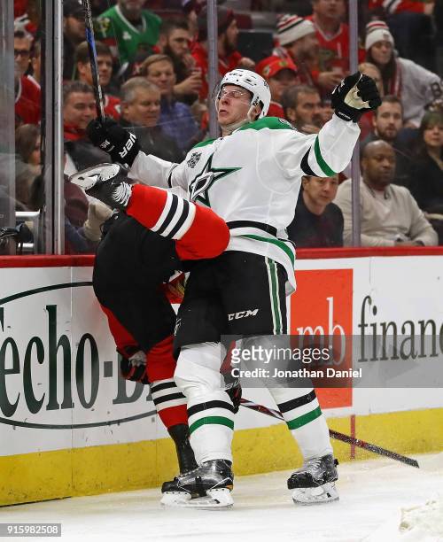 Esa Lindell of the Dallas Stars collides with Patrick Sharp of the Chicago Blackhawks along the boards at the United Center on February 8 2018 in...