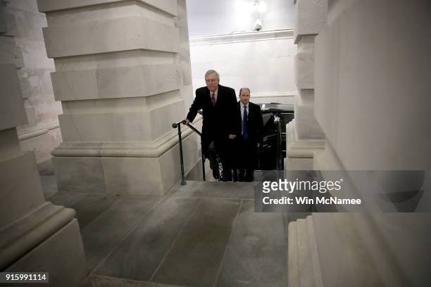 Senate Majority Leader Mitch McConnell returns to the U.S. Capitol just before midnight February 8, 2018 in Washington, DC. After a delay caused by...