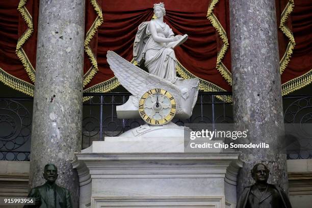 The clock in the National Statuary Hall shows midnight at the U.S. Capitol February 9, 2018 in Washington, DC. Despite attempts by Republicans and...