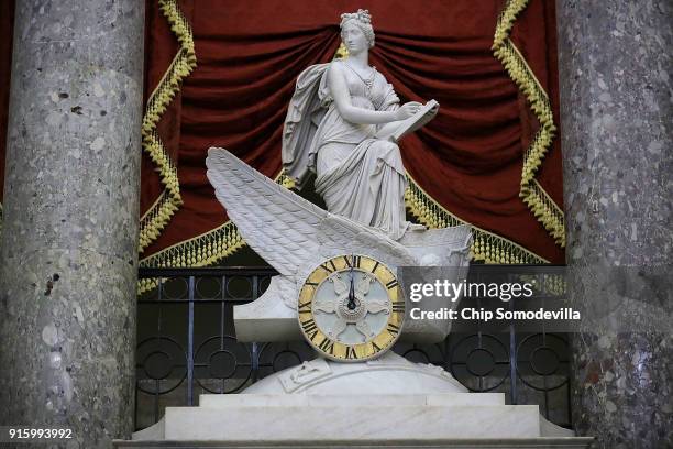 The clock in the National Statuary Hall shows midnight at the U.S. Capitol February 9, 2018 in Washington, DC. Despite attempts by Republicans and...