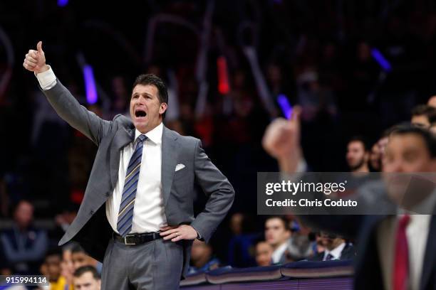 Head coach Steve Alford of the UCLA Bruins and head coach Sean Miller of the Arizona Wildcats gesture during the second half of the college...