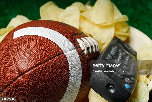the big game is on tv - american football on screen stock pictures, royalty-free photos & images