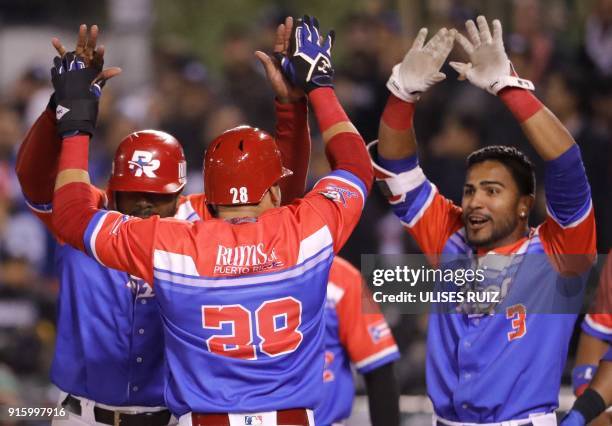 Dayron Varona of Criollos de Caguas from Puerto Rico celebrates with teammates after scoring against Aguilas Cibaenas of Republica Dominicana during...