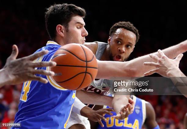 Parker Jackson-Cartwright of the Arizona Wildcats passes around Gyorgy Goloman of the UCLA Bruins during the second half of the college basketball...