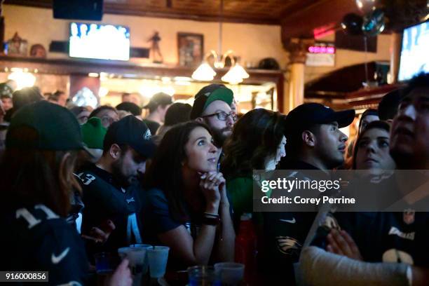 Tiffany Voll of Sydney, Australia looks watches Super Bowl LII on TV at The Irish Pub on February 4, 2018 in downtown Philadelphia, Pennsylvania....