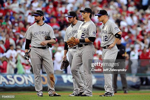 Todd Helton, Ian Stewart, Troy Tulowitzki and Clint Barmes of the Colorado Rockies look on during a pitching change in the sixth inning against the...