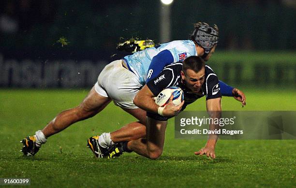 Chris Latham of Worcester is tackled by Florian Nicot during the Amlin Challenge Cup match between Worcester Warriors and Montpellier at Sixways on...