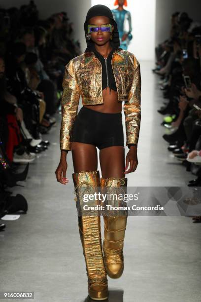 Maria Borges walks the runway wearing Jeremy Scott Fall 2018 with make up by Kabuki for MAC and hair by Eugene Souleiman for Wella at Spring Studios...