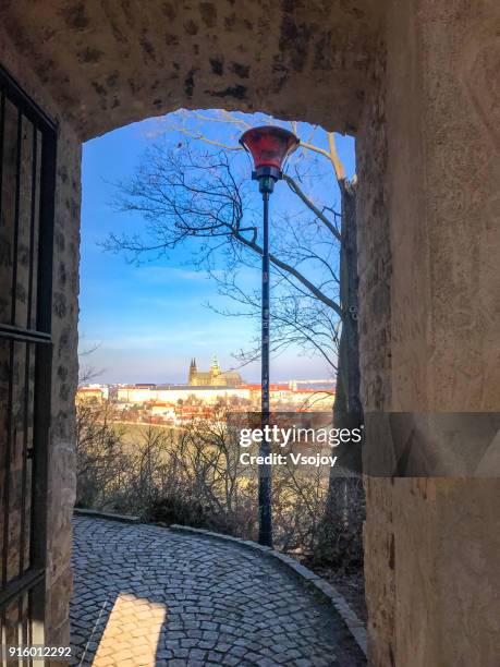 see prague castle through the gate at petrin hill, prague, czech republic - czech republic mountains stock pictures, royalty-free photos & images