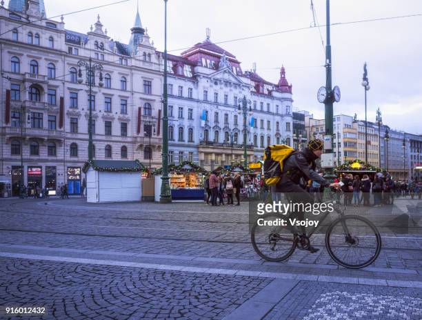bicycle rider in the city, prague, czech republic - vsojoy stockfoto's en -beelden