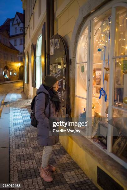 window shopping at lesser town, prague, czech republic - vsojoy stockfoto's en -beelden