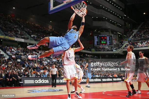 Carlos Boozer of the Utah Jazz dunks against Travis Hensen of Real Madrid in a pre-season game during the 2009 NBA Europe Live Tour on October 8,...