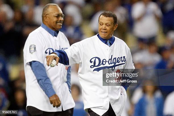 Former Los Angeles Dodgers Maury Wills and Tommy Davis throw out the first pitch before the Dodgers take on the St. Louis Cardinals in Game One of...