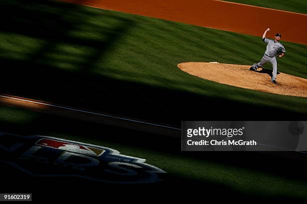 Starting pitcher Aaron Cook of the Colorado Rockies throws a pitch against the Philadelphia Phillies in Game Two of the NLDS during the 2009 MLB...
