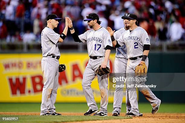 Clint Barmes, Todd Helton, Ian Stewart and Troy Tulowitzki of the Colorado Rockies celebrate their 5-4 win against the Philadelphia Phillies in Game...