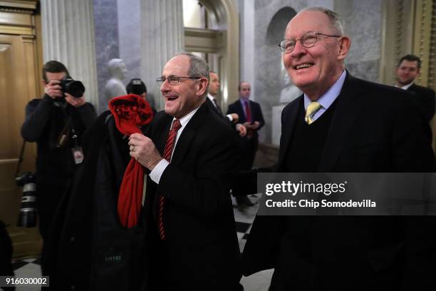 Sen. James Risch and Sen. Lamar Alexander leave the U.S. Capitol following early morning votes February 9, 2018 in Washington, DC. Despite an attempt...