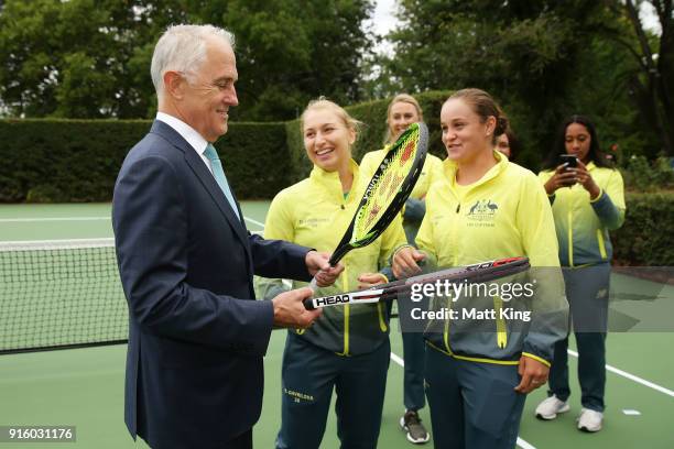 Daria Gavrilova and Ashleigh Barty of Australia present the Prime Minister of Australia Malcolm Turnbull two tennis raquests as a gift during a Prime...