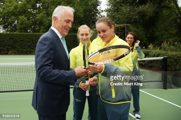 Daria Gavrilova and Ashleigh Barty of Australia present the Prime Minister of Australia Malcolm Turnbull two tennis raquests as a gift during a Prime...