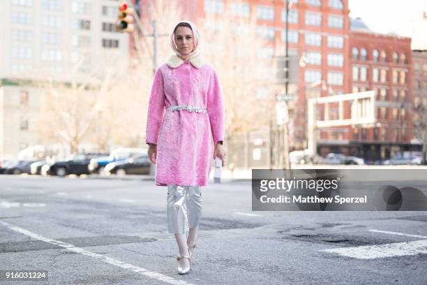 Mademoiselle Meme is seen on the street attending Colovos and Noon By Noor during New York Fashion Week wearing a pink fur coat and silver pants on...