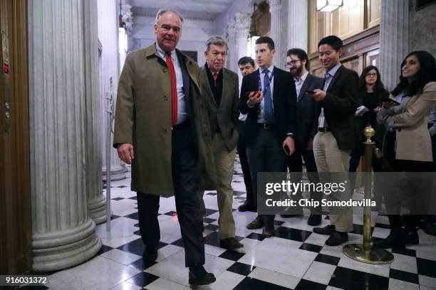 Sen. Tim Kaine and Sen. Roy Blunt pass by repoters on their way to the Senate Chamber for early morning votes at the U.S. Capitol February 9, 2018 in...