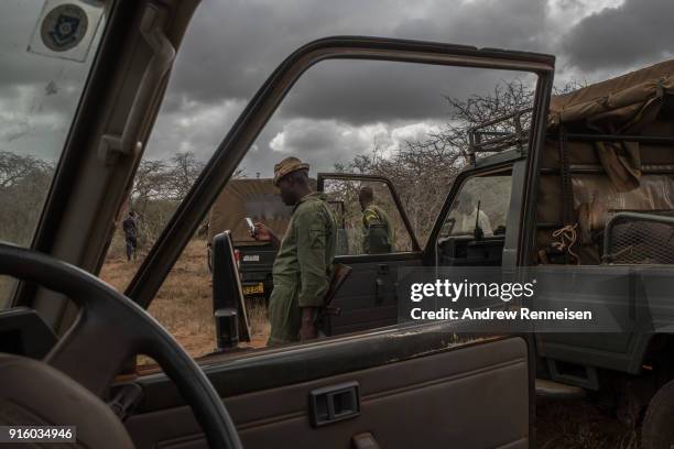 An elephant collaring team takes a break during an operation on February 2, 2018 in an area of ranches in Taita-Taveta County, Kenya. The operation...