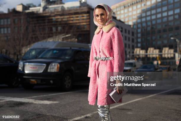 Mademoiselle Meme is seen on the street attending Tadashi Shoji during New York Fashion Week wearing a pink coat and silver pants on February 8, 2018...