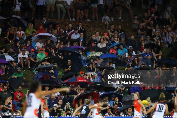 The crowd watch on as rain falls during the round 20 AFLW match between the Greater Western Sydney Giants and the Carlton Blues at Drummoyne Oval on...