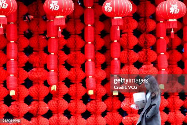 Girl walks past an intangible cultural heritage museum decorated with red lanterns on February 9, 2018 in Shaoxing, Zhejiang Province of China....