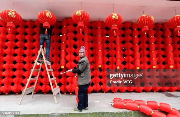 Workers set lanterns to welcome Lunar New Year at an intangible cultural heritage museum on February 9, 2018 in Shaoxing, Zhejiang Province of China....