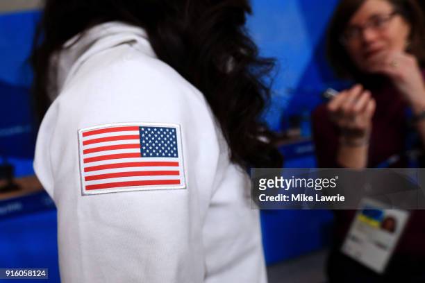 Detail view of the American flag on Aja Evans shirt as she speaks during the United States Women's Bobsleigh Team press conference ahead of the...