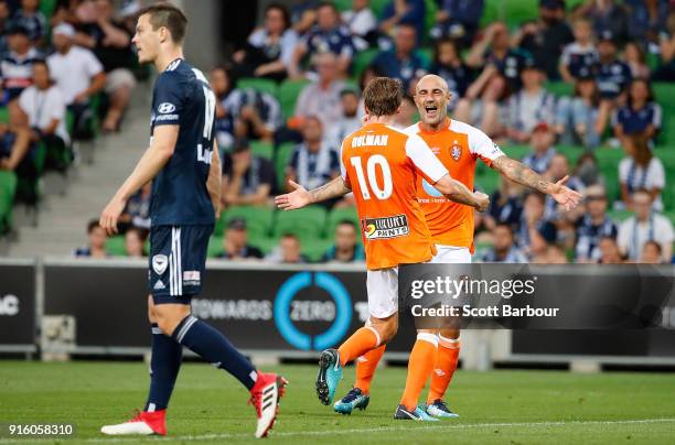 Brett Holman of the Roar is congratulated by Massimo Maccarone after scoring the Roars second goal during the round 20 A-League match between the...