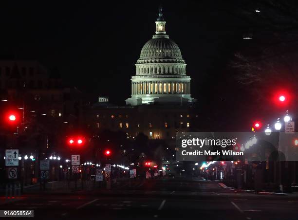 Lights shine down Pennsylvania Avenue leading to the U.S. Capitol in the early hours of Friday morning on February 9, 2018 in Washington, DC. Despite...