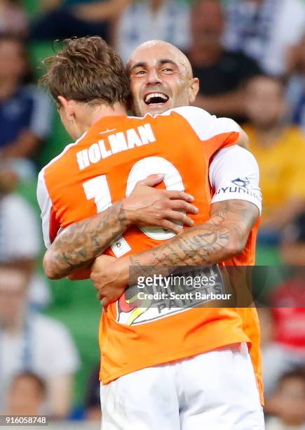 Brett Holman of the Roar is congratulated by Massimo Maccarone after scoring the Roars second goal during the round 20 A-League match between the...